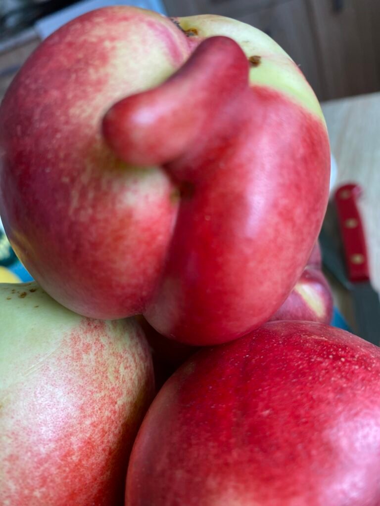 Apples stacked closely together, their shapes overlapping.